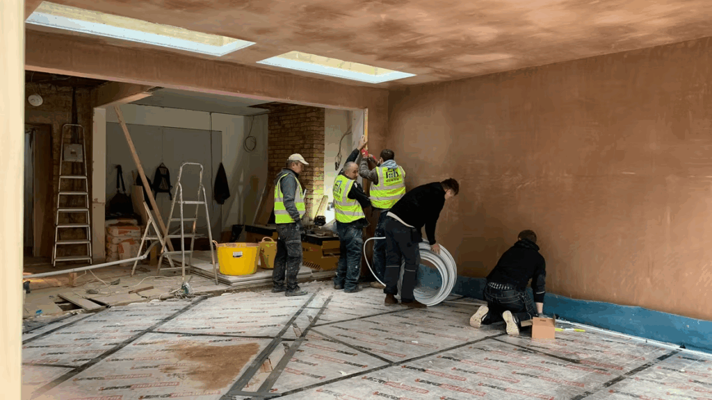 Ecron renovation and extension specialists working on a residential property with scaffolding and company van on site